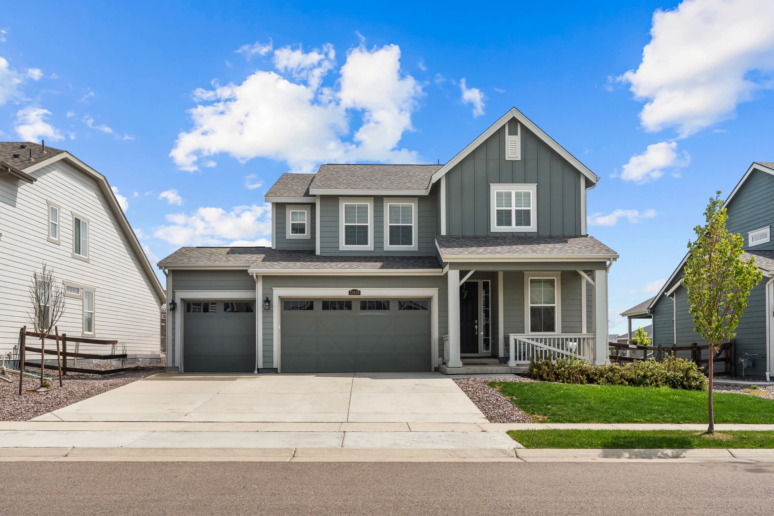 Exterior front elevation of a two-storey home under a blue sky