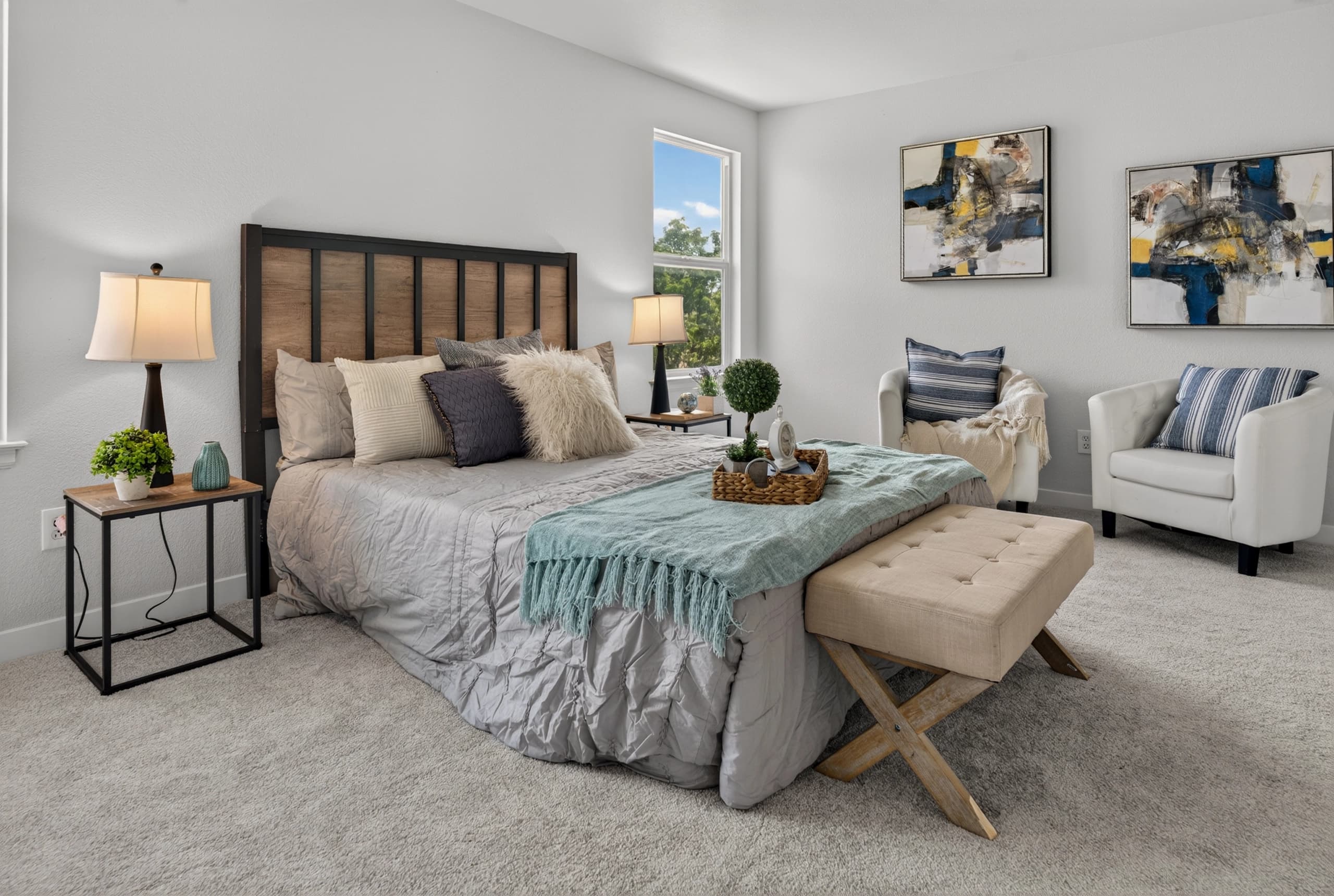 Interior bedroom with a sitting area and artwork