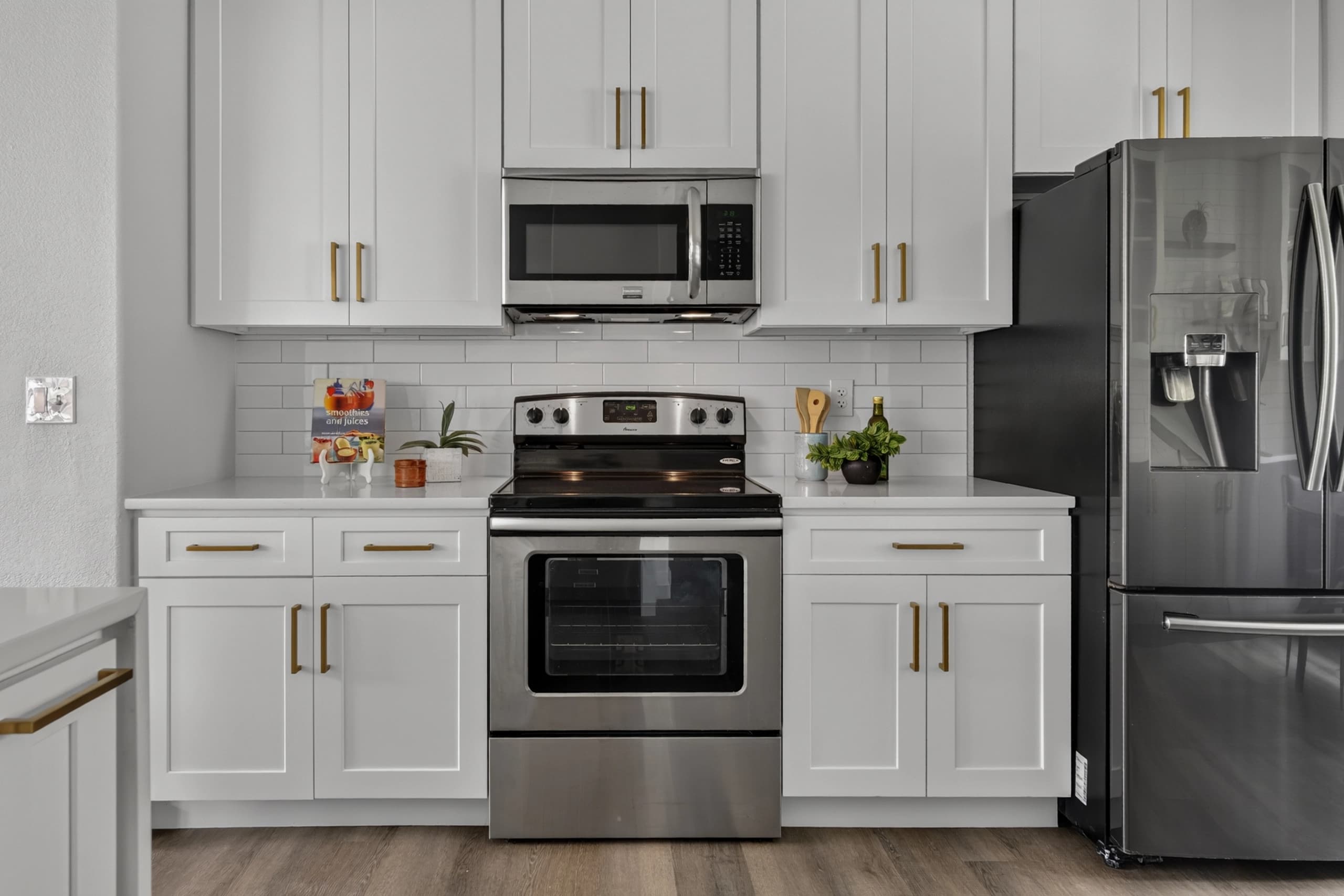 Interior kitchen with white cabinetry and stainless appliances